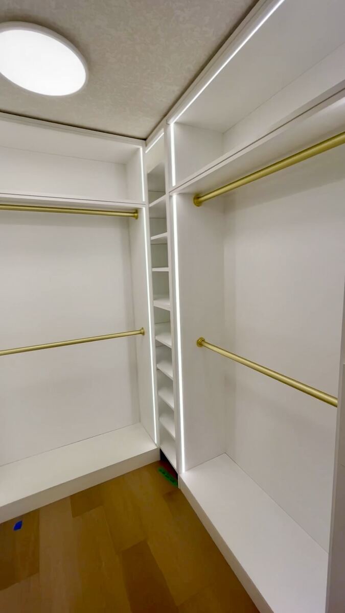 Custom closet with integrated LED backlit shelving